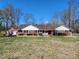 Charming single-story brick home with a well-maintained lawn and an American flag flying out front at 1301 Huckleberry Dr, Lincolnton, NC 28092