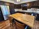 Modern kitchen features stainless steel appliances, a center island with seating, and dark cabinets at 1301 Huckleberry Dr, Lincolnton, NC 28092