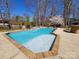 Inviting in-ground pool with a brick border, clear blue water, and a serene stone waterfall feature at 1301 Huckleberry Dr, Lincolnton, NC 28092