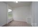 This bedroom features a window for natural light, neutral carpet, white trim, and an alcove at 1413 Caldwell St, Gastonia, NC 28052