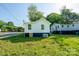 Rear exterior view of the home featuring a new side door and painted foundation at 1413 Caldwell St, Gastonia, NC 28052