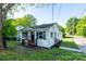 Charming cottage-style home with white siding, black shutters and a cozy front porch at 1413 Caldwell St, Gastonia, NC 28052