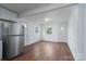Living area featuring a stainless fridge, wood-look floors and natural light at 1413 Caldwell St, Gastonia, NC 28052