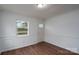 Living room featuring beautiful wood-look flooring, decorative trim, and bright natural light at 1413 Caldwell St, Gastonia, NC 28052