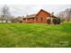Expansive lawn and brick home exterior, perfect for outdoor activities and gatherings at 161 Seven Springs Loop # 11, Statesville, NC 28625