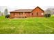 Spacious backyard with a wooden deck and a well-maintained lawn at 161 Seven Springs Loop # 11, Statesville, NC 28625