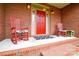 Inviting covered front porch featuring rocking chairs, a bright red door, and classic brick accents at 161 Seven Springs Loop # 11, Statesville, NC 28625
