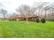 Sprawling front yard of brick home, showcasing mature trees and established landscaping at 161 Seven Springs Loop # 11, Statesville, NC 28625