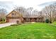 Charming brick home featuring a well-manicured lawn, established landscaping, and attached two-car garage at 161 Seven Springs Loop # 11, Statesville, NC 28625