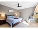 Neutral colored bedroom featuring a tray ceiling, fan, and ample natural light at 1614 Shimron Ln, Waxhaw, NC 28173