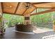 Gorgeous deck features an outdoor fireplace and ceiling fan at 1614 Shimron Ln, Waxhaw, NC 28173