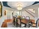 Chic dining room featuring a chandelier, dark-framed chairs, and view of the staircase at 1614 Shimron Ln, Waxhaw, NC 28173