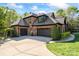 Spacious driveway leading to a three-car garage on a charming brick home with landscaped greenery at 1614 Shimron Ln, Waxhaw, NC 28173