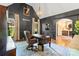 Sophisticated office with dark walls, wainscoting, vaulted ceilings, and a large executive desk at 1614 Shimron Ln, Waxhaw, NC 28173