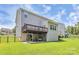 Spacious backyard featuring a deck, patio, green grass, and a partially fenced yard at 1809 Mill Creek Sw Ln, Concord, NC 28025