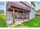 Covered patio area with outdoor seating and slide with spacious backyard at 1809 Mill Creek Sw Ln, Concord, NC 28025