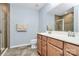 Well-lit bathroom showcasing a double sink vanity, framed mirror, neutral color scheme, and glass-enclosed shower at 1809 Mill Creek Sw Ln, Concord, NC 28025