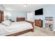 A bedroom featuring light blue walls, stylish furniture, and a wall-mounted TV for modern comfort and convenience at 1809 Mill Creek Sw Ln, Concord, NC 28025