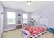 Cozy bedroom with lilac walls, play area, two windows, and carpet flooring at 1809 Mill Creek Sw Ln, Concord, NC 28025