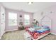 A bedroom in light purple with toys, a bed, and lots of natural light from two windows at 1809 Mill Creek Sw Ln, Concord, NC 28025