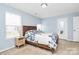Bedroom with neutral color scheme, wood trim, bright, natural light, and light blue walls at 1809 Mill Creek Sw Ln, Concord, NC 28025