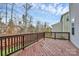 Large wooden deck with railing overlooking a grassy yard and trees in the background at 1809 Mill Creek Sw Ln, Concord, NC 28025