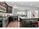 Spacious kitchen with stainless steel appliances, granite countertops, and an island with bar seating at 1809 Mill Creek Sw Ln, Concord, NC 28025