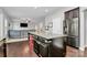 Features a kitchen island with granite countertops, bar seating, and stainless steel refrigerator at 1809 Mill Creek Sw Ln, Concord, NC 28025