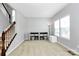 Open living room featuring a staircase, window, storage cabinet, and neutral decor at 1809 Mill Creek Sw Ln, Concord, NC 28025