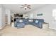Bright and airy living room features sectional sofa, built-in shelving, and adjacent eat in kitchen at 1809 Mill Creek Sw Ln, Concord, NC 28025