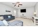 Comfortable living room featuring reclining sofa, media center, and neutral decor at 1809 Mill Creek Sw Ln, Concord, NC 28025