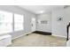 Bright living room with a large window, light gray walls, and wood-look entry flooring at 1809 Mill Creek Sw Ln, Concord, NC 28025