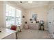 Neutral bedroom with a large window, blinds, ceiling fan, and carpeted floor with a desk and furniture at 18125 Ebenezer Dr, Cornelius, NC 28031