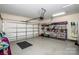 Spacious two-car garage featuring ample storage shelves and an organized layout with painted flooring at 18125 Ebenezer Dr, Cornelius, NC 28031