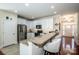 Bright kitchen features white cabinets, granite countertops, stainless steel appliances, and a breakfast bar at 18125 Ebenezer Dr, Cornelius, NC 28031