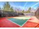 Outdoor community tennis court surrounded by trees, a net and a privacy screen at 18125 Ebenezer Dr, Cornelius, NC 28031