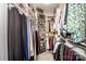 Organized walk-in closet with custom shelving, hanging rods, and storage baskets for clothing and accessories at 18125 Ebenezer Dr, Cornelius, NC 28031