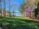 Lush backyard with mature trees, a view of the lake and a private dock at 1832 Marthas Vineyard Rd, York, SC 29745