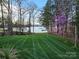 Beautiful backyard with green grass leading to a lake with a private dock at 1832 Marthas Vineyard Rd, York, SC 29745