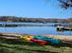Lake scene with sandy beach, kayaks on shore, and boat docks visible in the background at 1832 Marthas Vineyard Rd, York, SC 29745