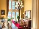 Bright and airy dining room with a large window, chandelier, and a long wooden table set for a formal meal at 1832 Marthas Vineyard Rd, York, SC 29745