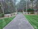 Long driveway leading to a beautiful home, flanked by stone walls and lush greenery at 1832 Marthas Vineyard Rd, York, SC 29745