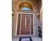 Elegant front door with decorative windows, flanked by sconces and set in a brick facade at 1832 Marthas Vineyard Rd, York, SC 29745