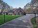 Stately home exterior with stone and brickwork, lush lawn and black lamp posts lining the driveway at 1832 Marthas Vineyard Rd, York, SC 29745