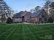 Beautiful home with brick and stone facade, complemented by a manicured lawn and landscaping at 1832 Marthas Vineyard Rd, York, SC 29745