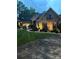 Well-lit exterior view of the home at dusk with manicured lawn and stone facade at 1832 Marthas Vineyard Rd, York, SC 29745