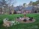 Landscaped front yard with a charming fountain and stone bench, set against a brick and stone home at 1832 Marthas Vineyard Rd, York, SC 29745