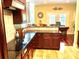 Stylish kitchen with dark cabinetry, granite counters, a tile backsplash, and an open layout connected to the dining area at 1832 Marthas Vineyard Rd, York, SC 29745
