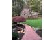 Beautifully landscaped walkway and flower garden with mature trees and a well manicured lawn at 1832 Marthas Vineyard Rd, York, SC 29745