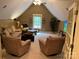 Upstairs living room with comfortable seating, neutral tones, a window, and a TV, creating a cozy retreat space at 1832 Marthas Vineyard Rd, York, SC 29745
